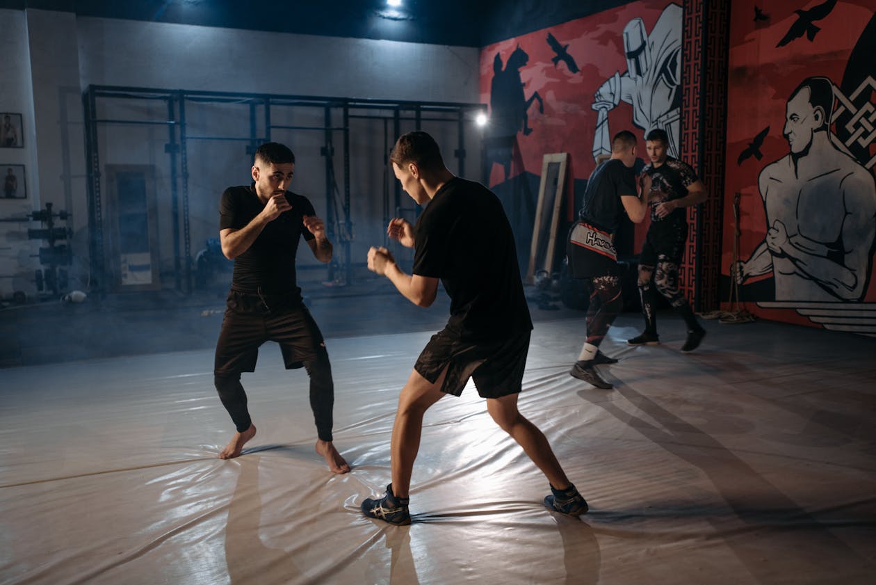 Martial artists sparring intensely on the mat during a no-gi training session