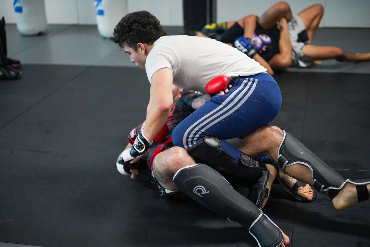 Grapplers engaged in no-gi sparring with one athlete retaining open guard