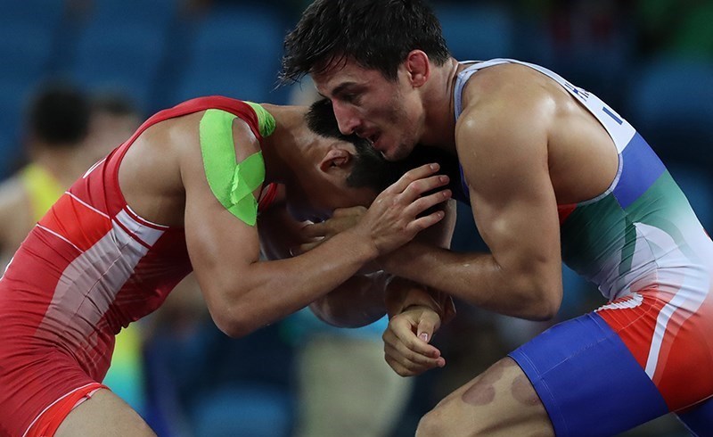 Olympic wrestling competition showcasing fundamental grappling techniques used in submission wrestling