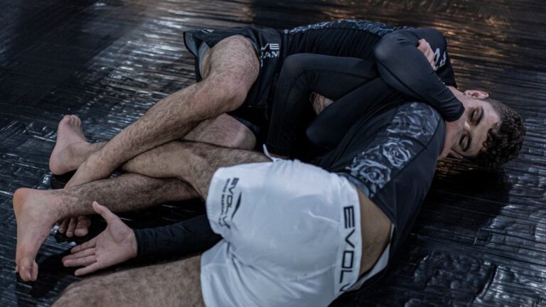 Anaconda choke no gi BJJ technique demonstrated by two grapplers in rashguard and shorts