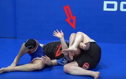 Anaconda choke no gi BJJ finish position with attacker rolling opponent over trapped arm