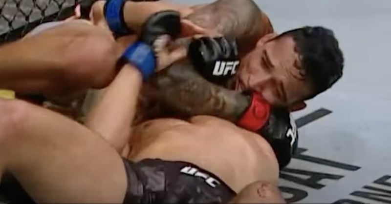 Mixed martial artist locking in arm triangle anaconda choke against opponent in UFC bout