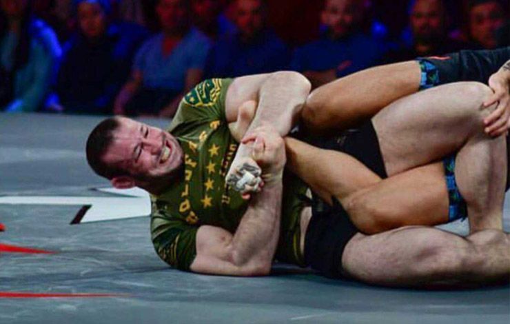 Aaron Tex Johnson in a deep ashi garami leg entanglement at a competitive no-gi event
