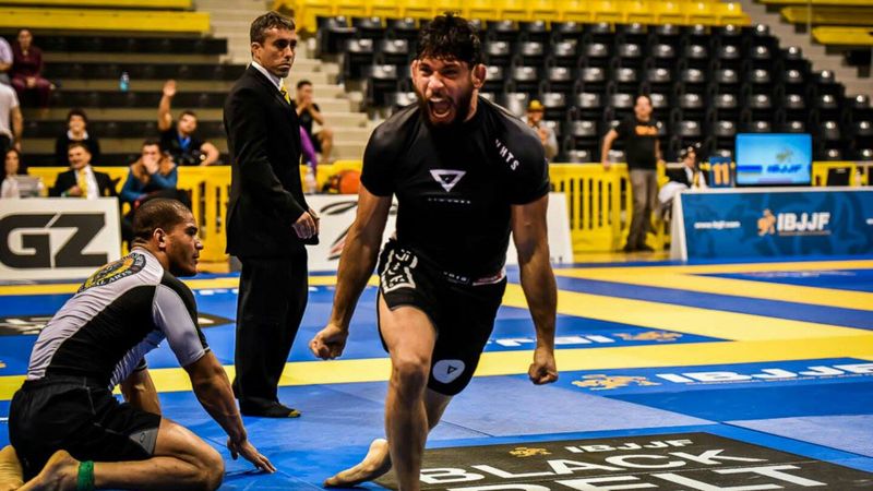 BJJ competitor celebrating a darce choke submission win in no-gi