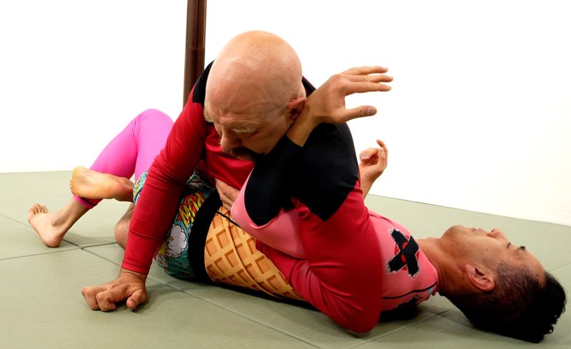 Kimura BJJ attack from top half guard, no-gi rashguard grappler