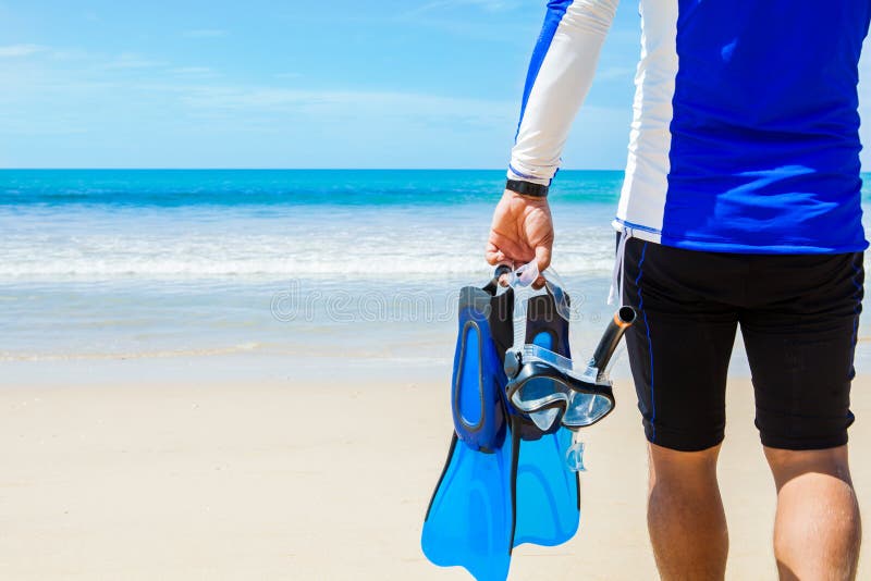 Man with snorkeling gear in hands going to sea on beach. Snorkeling gear isolated stock images, royalty-free photos and pictu