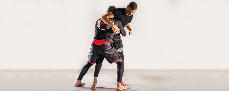 No-gi grapplers clinch fighting for underhooks before a takedown