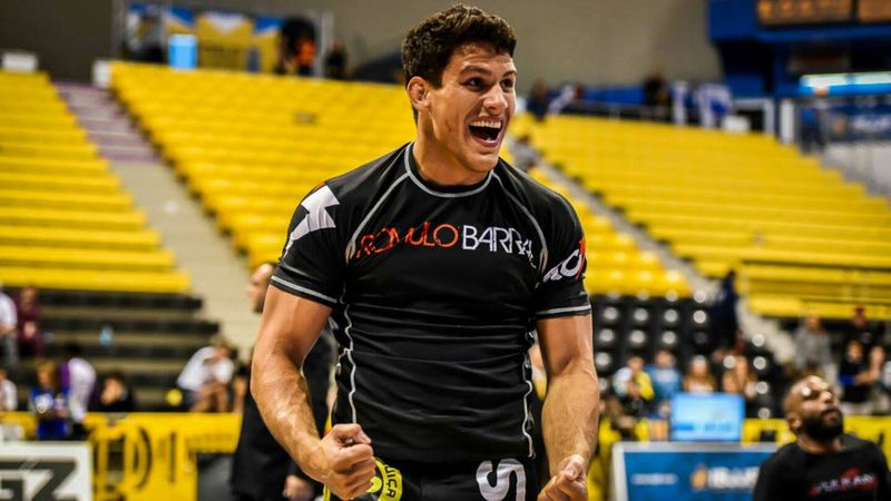 No-gi BJJ black belt celebrating after a darce choke submission