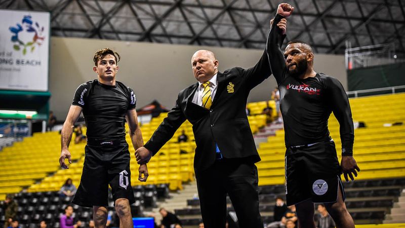 Two no-gi grapplers after a darce choke finish at a BJJ tournament