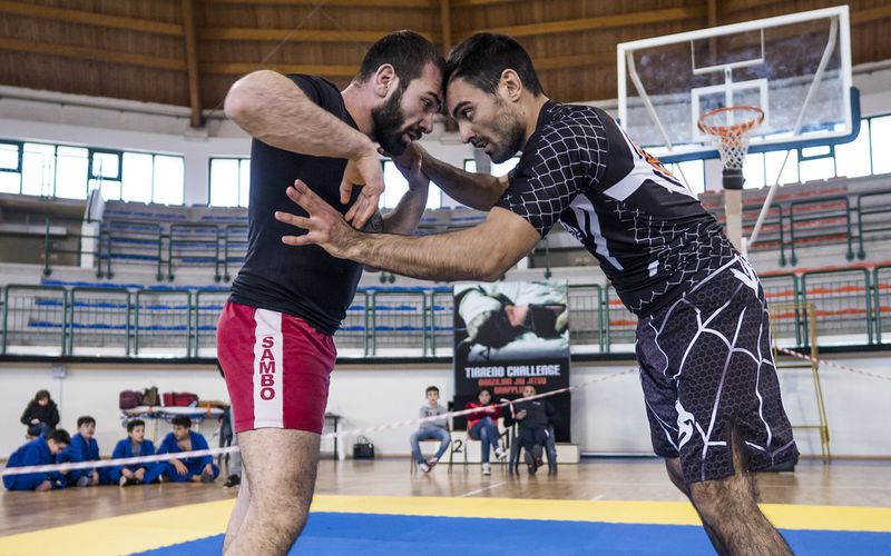 No-gi grapplers clinching in a standing scramble before hitting the mat