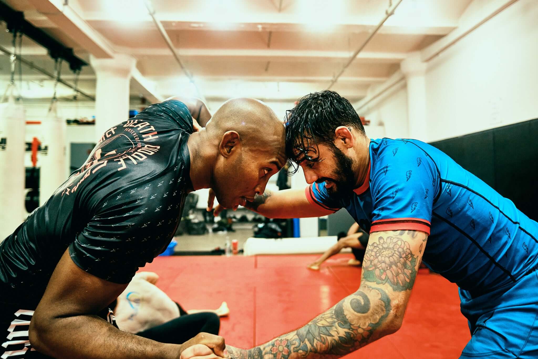 Two Jiu Jitsu athletes wearing Nation Athletic BJJ short, one wear blue shorts and the other black bjj shorts.