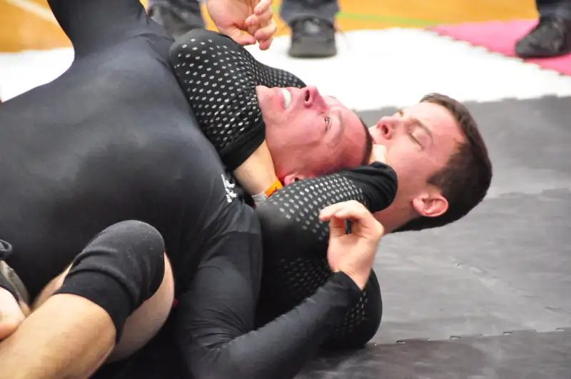 Rear naked choke applied from back control in a no-gi grappling match