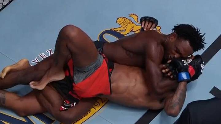 A fighter finishing the twister submission inside the cage