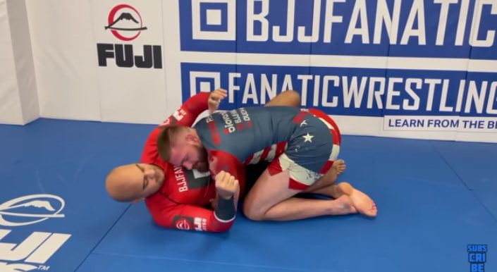 No-gi body lock guard pass showing forward pressure on the mats