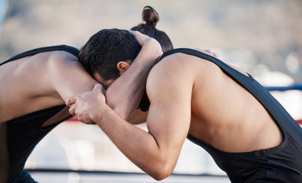 Sports, gym and training with men and wrestling match for fight, championship and action. Fitness, workout and exercise with