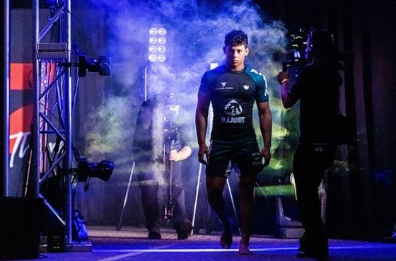Grappler walking out in a rashguard before a no-gi competition match