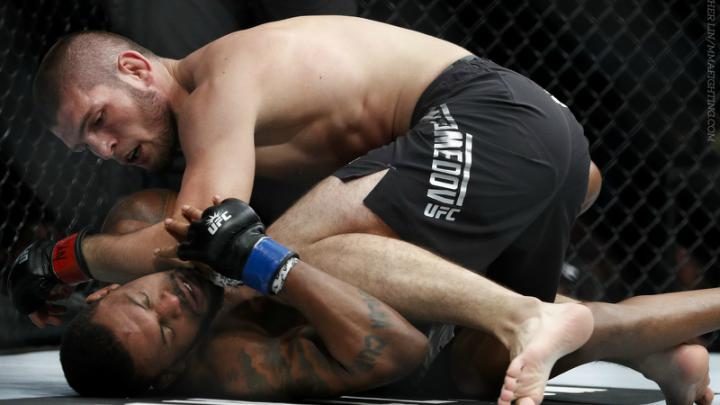 Smaller fighter working to escape bottom side control in no-gi