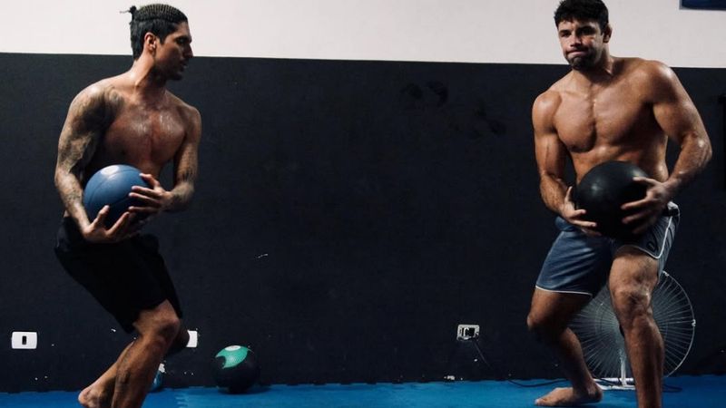No-gi grapplers doing strength conditioning to finish the arm triangle squeeze