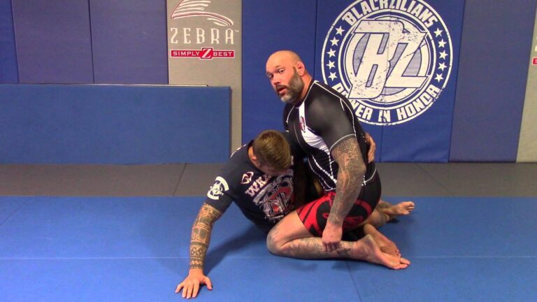 No-gi half guard: top grappler in a rashguard working to pass the bottom player's half guard