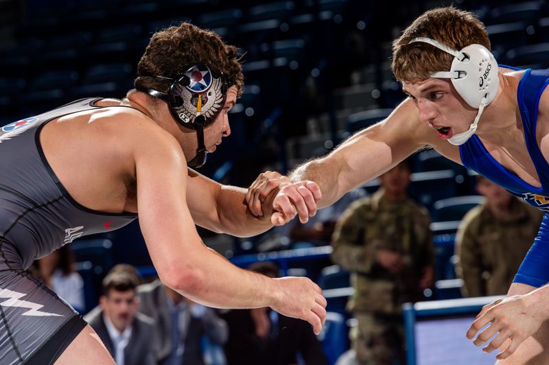 Wrestlers wearing headgear ear protection in no-gi match to prevent cauliflower ear