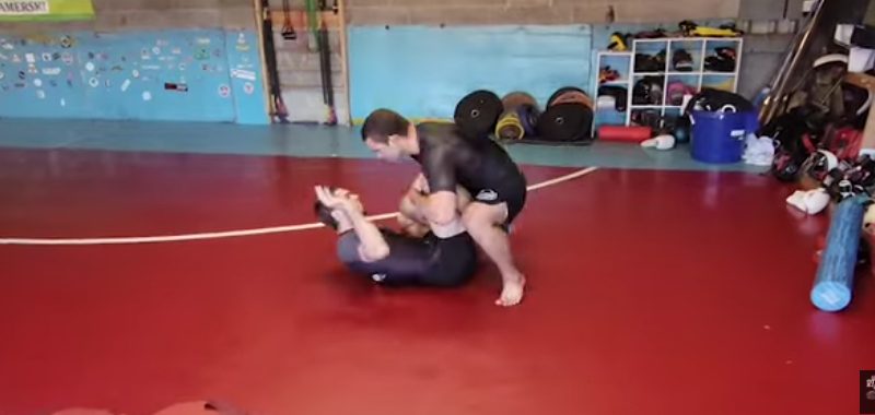 No-gi grapplers drilling a passing sequence in training