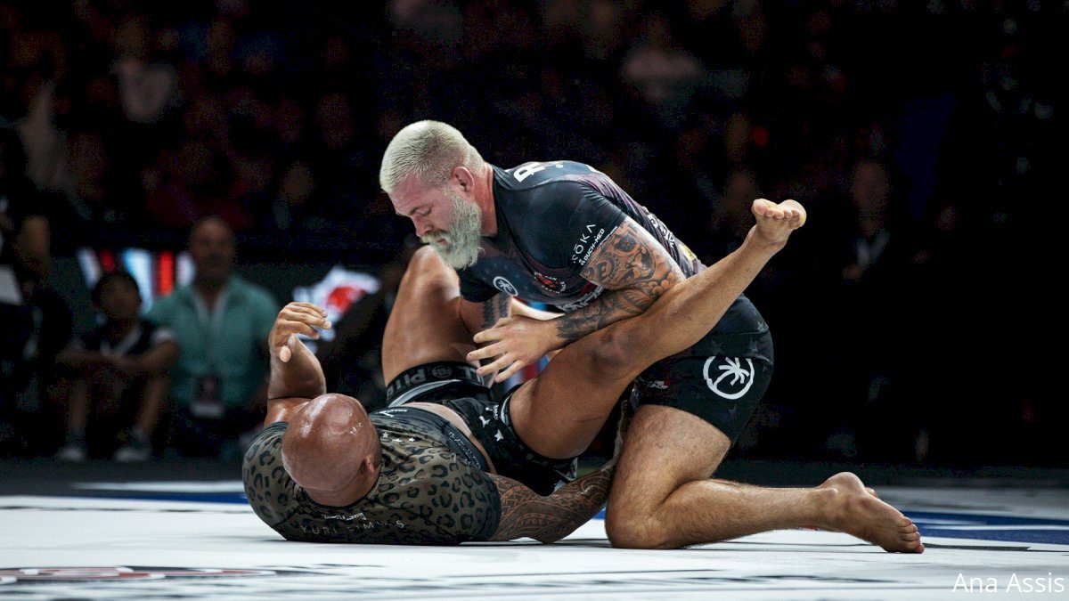 No-gi grappler defending heavy top control before a mount escape