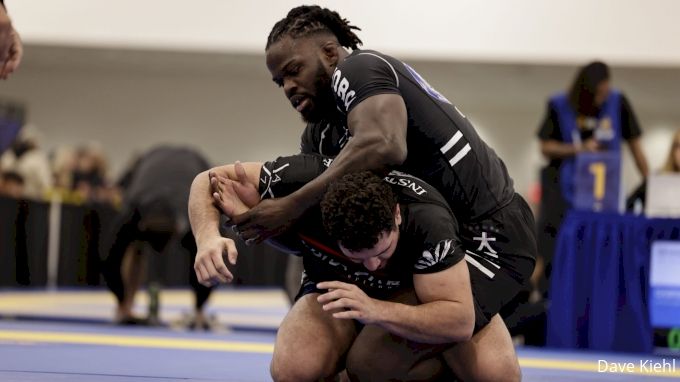 Two grapplers in black no-gi competition rashguards