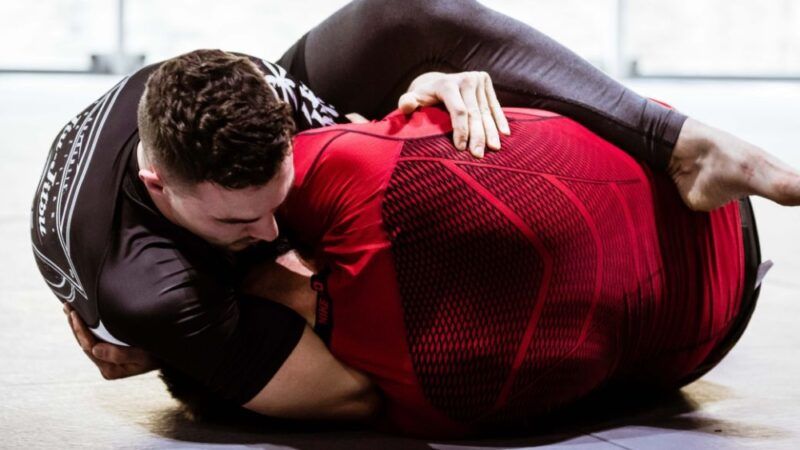 No gi grappler controlling opponent from front headlock