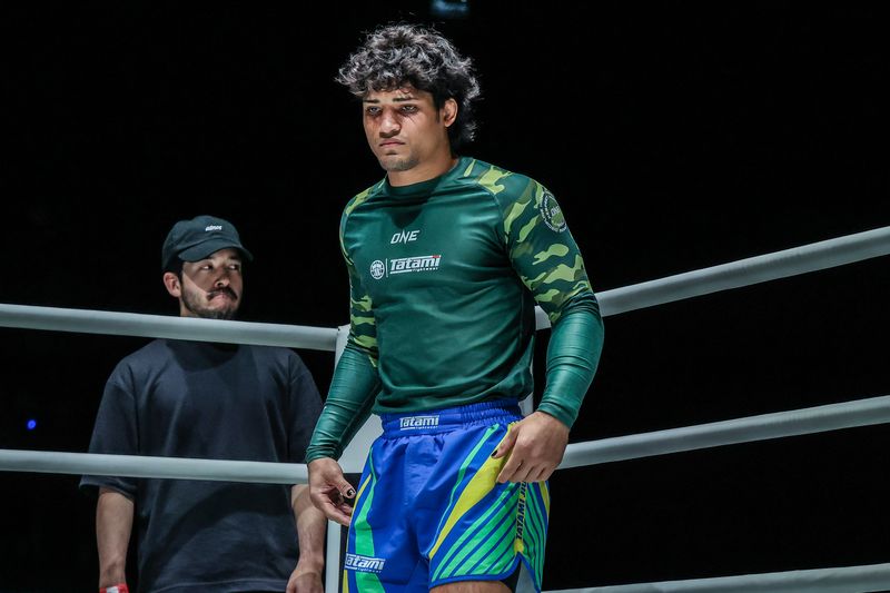 No-gi grappler in a rashguard and fight shorts before competing
