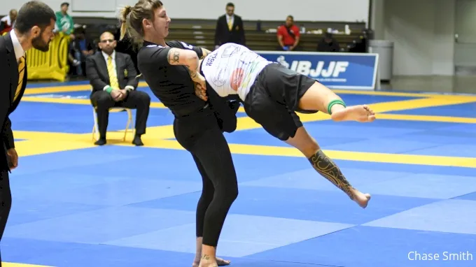 No-gi grappler in a tight-fitting rashguard executing a throw during competition