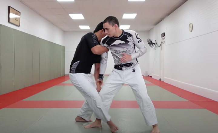 two grapplers in rashguards clinching during a no-gi roll