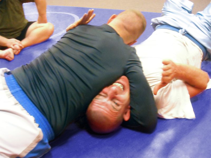 Grapplers demonstrating the north-south choke position in no-gi