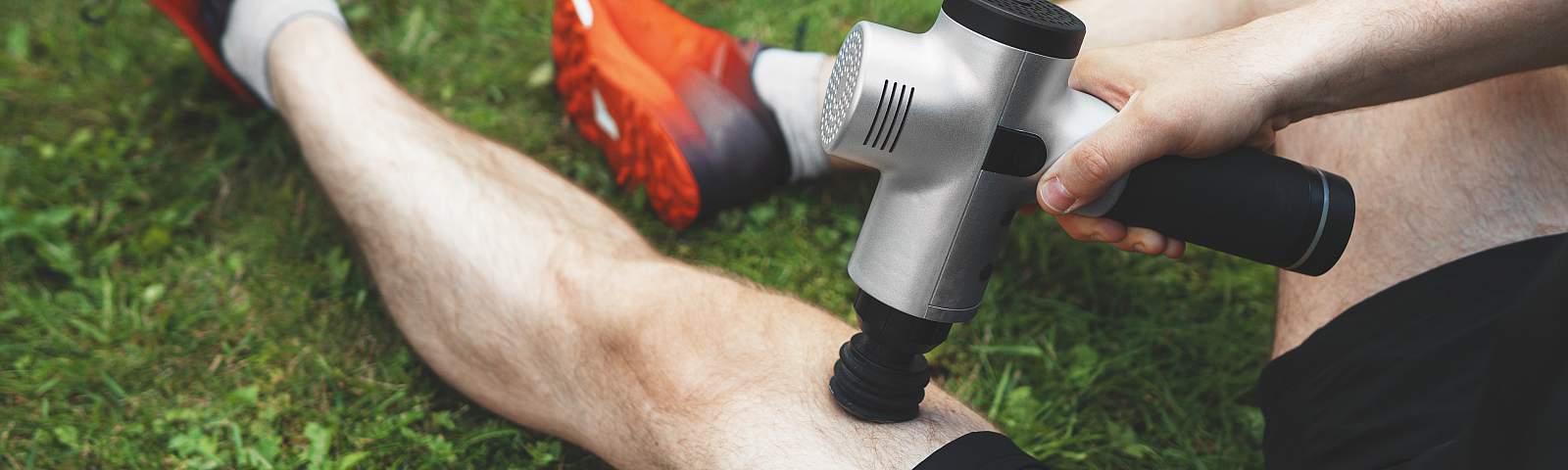 TitleMan massaging leg with massage percussion device after workout.