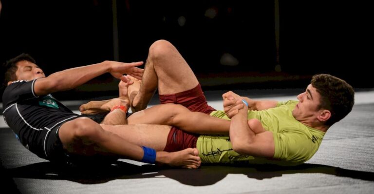 Two no-gi grapplers battling for a straight ankle lock in a leg entanglement