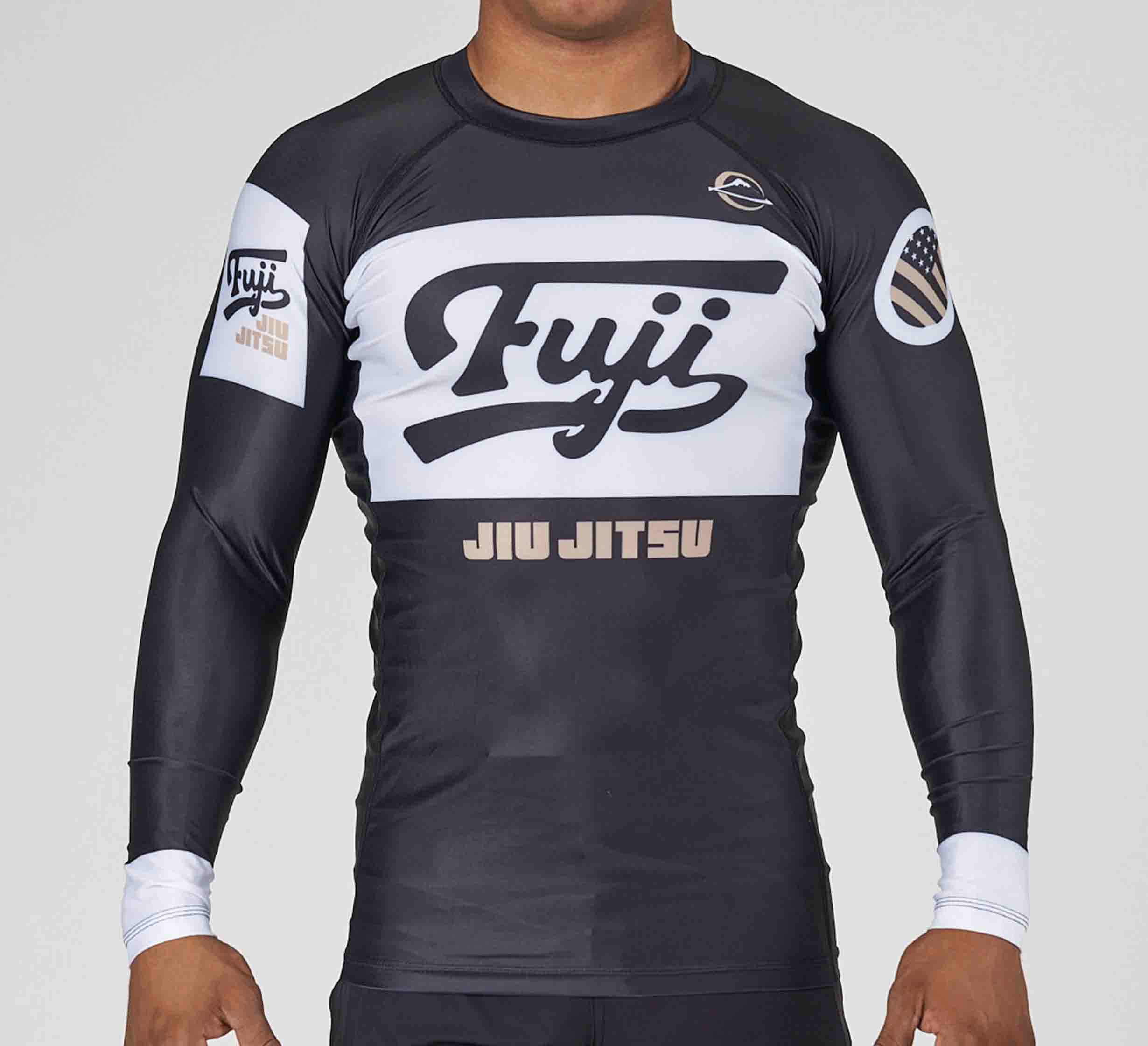A person wearing the Jiu Jitsu Script Flex Lite Long Sleeve Rashguard in black, featuring Fuji and Jiu Jitsu text on the fron