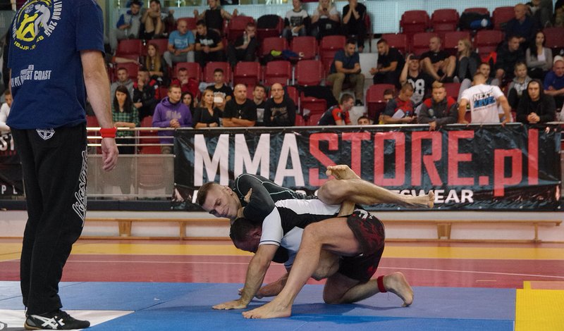 No-gi grappler shooting a single-leg entry, a common path into X-guard