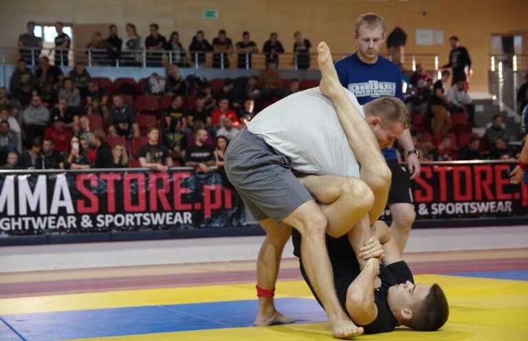 X-guard no-gi sweep battle as a grappler works to off-balance a standing opponent