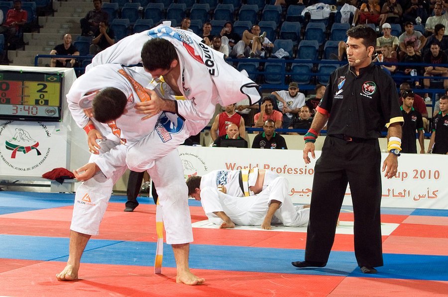 BJJ competitor securing back control position during grappling competition