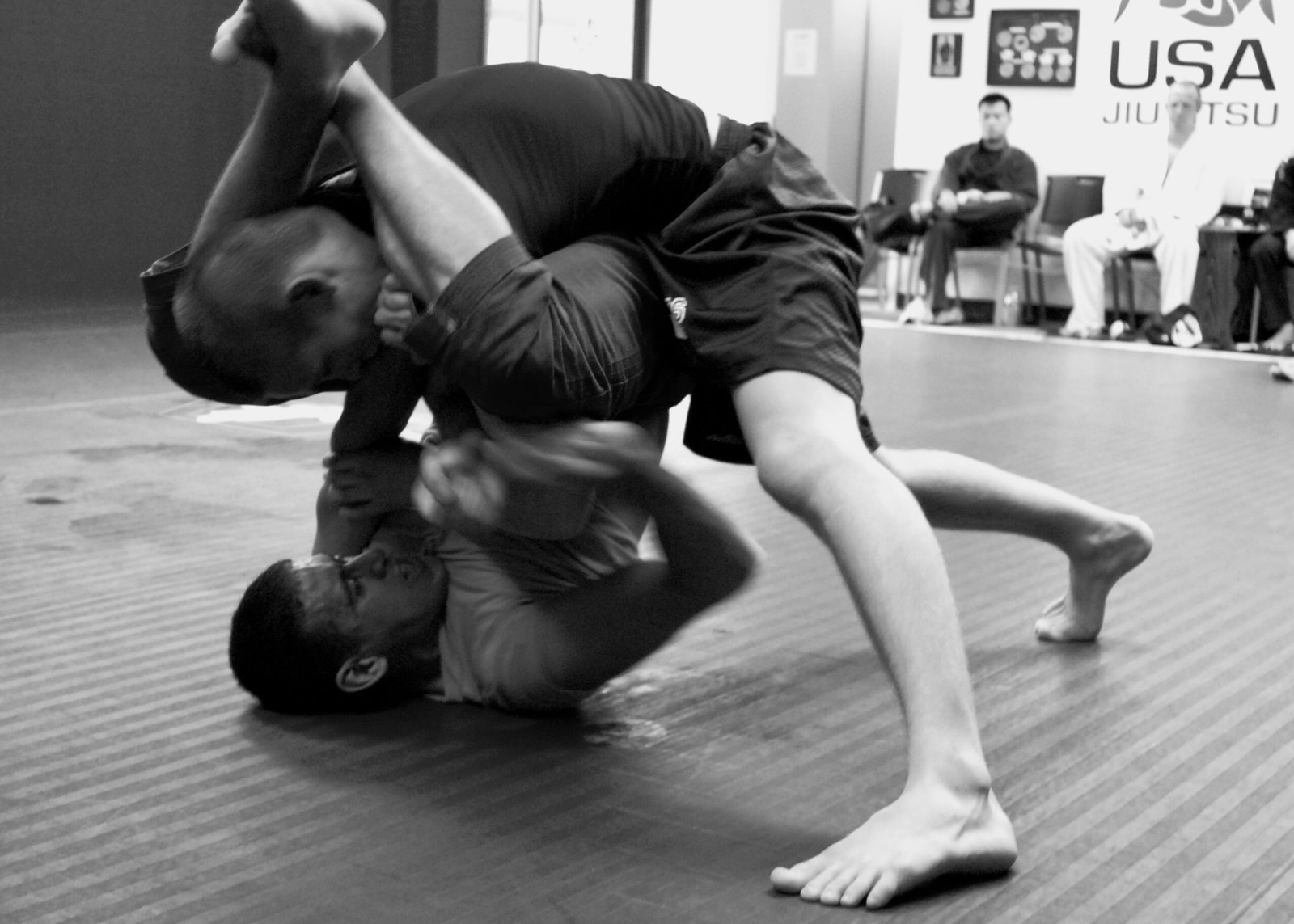 No-gi grappling training in rashguard showing the competitive training environment of elite submission grapplers