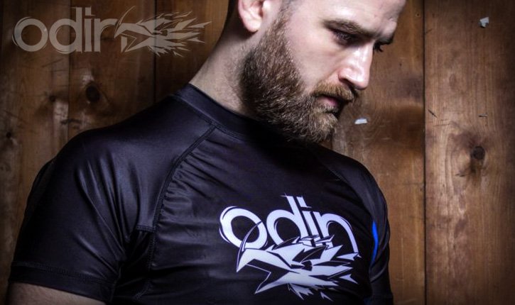 Close-up of a rashguard collar and shoulder seam construction on a no-gi grappler