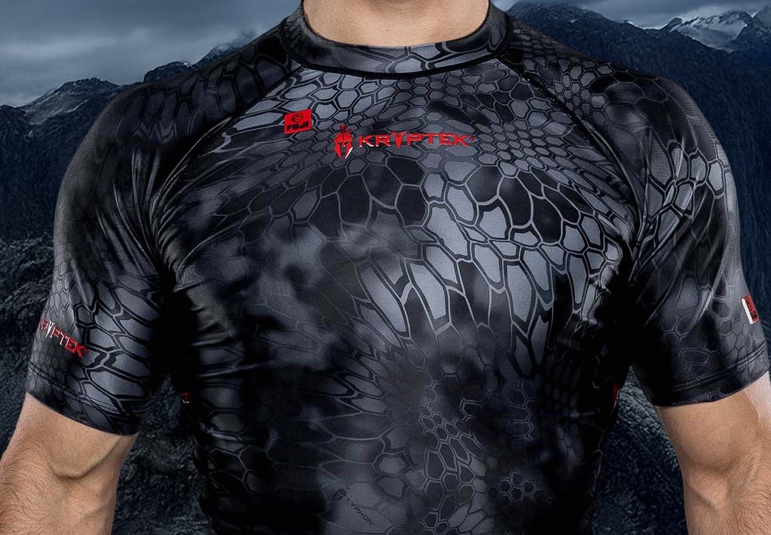 Close-up of compression rashguard fabric pulled tight across the chest and shoulders, illustrating correct sizing