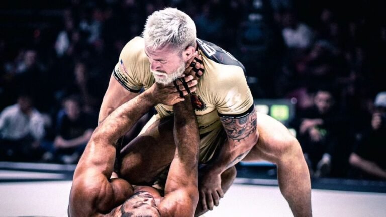 Grappler driving forward pressure while passing an opponent's guard in no-gi competition