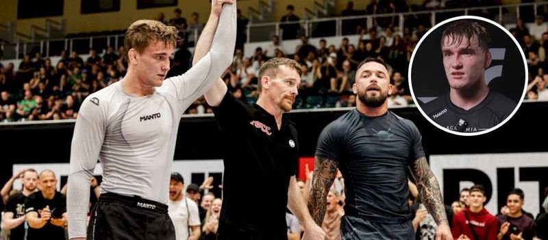 A no-gi grappling champion has his hand raised in a compression rashguard after a title win
