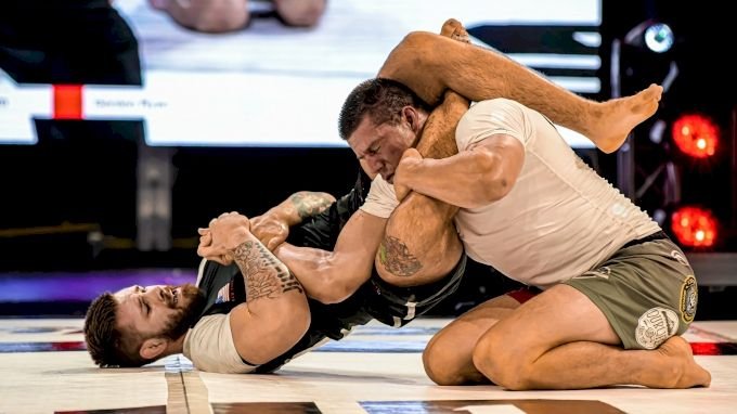 No-gi grapplers in a scramble, rashguard fabric stretched under grip pressure