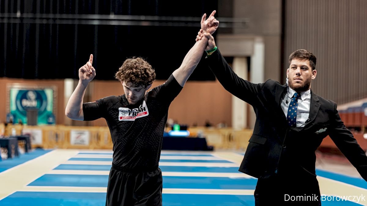 No-gi rashguard competitor having their arm raised after a tournament win