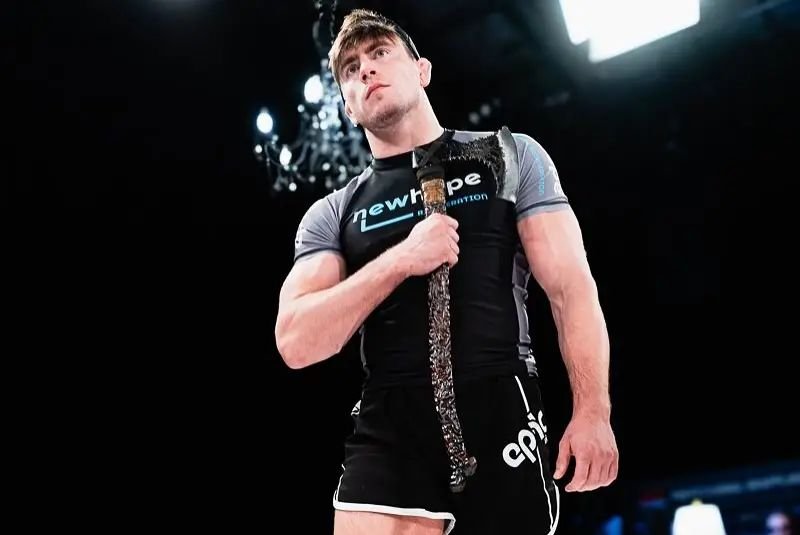 PGF no-gi grappling champion holding the league title belt