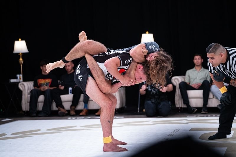 Two no-gi grapplers battling for position in a PGF submission grappling match