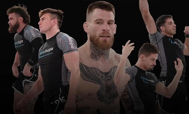 PGF team grapplers in matching no-gi rashguard uniforms after a match