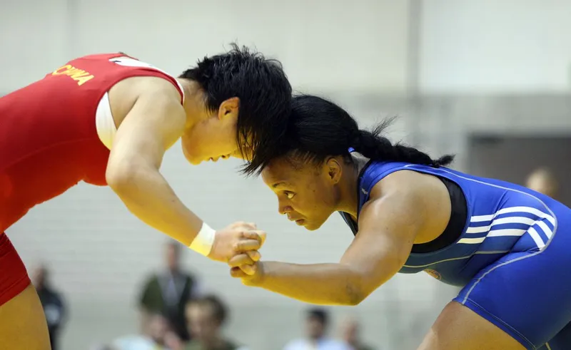 Wrestlers hand fighting from a collar tie before shooting a single leg takedown