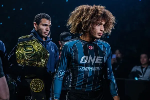 No-gi grappling champion in rashguard walking to the mat before a submission grappling match